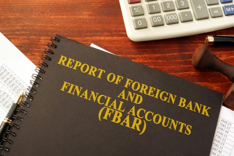 FBAR Reporting book with a calculator on a desk
